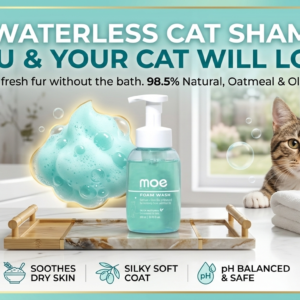 A premium e-commerce hero banner for Moe Puppy Foam Wash featuring a teal-colored bottle on a marble tray. Beside the product, a calm tabby cat is positioned next to a clean white towel in a bright, modern bathroom setting. The banner includes benefit icons for waterless cleaning and a "Shop Now" button.